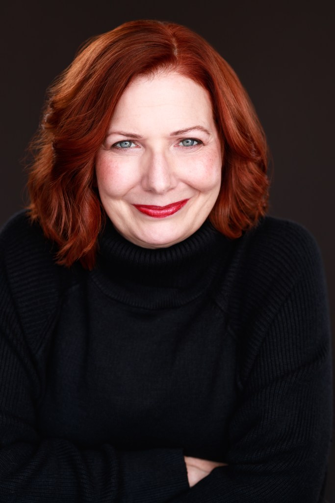 Red haired woman with red lipstick and black turtleneck sweater